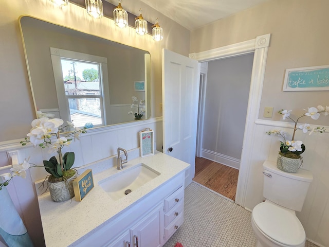 1323 Lincoln Ave, Saint Paul, MN 55105 - bathroom with vanity, toilet, and wainscoting