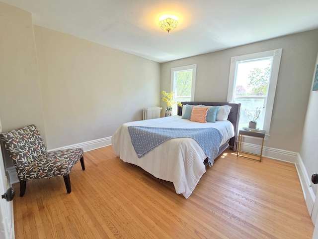1323 Lincoln Ave, Saint Paul, MN 55105 - bedroom featuring radiator heating unit, light wood-style floors, and baseboards