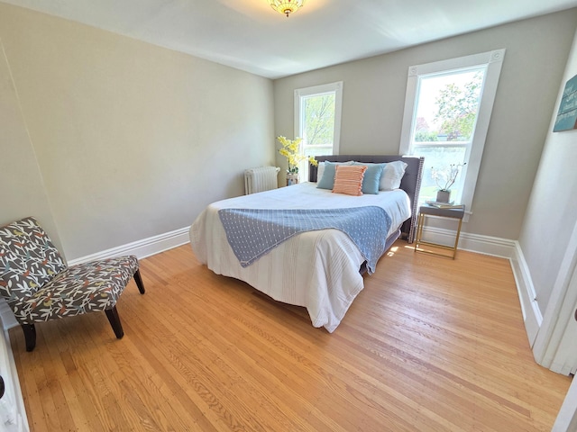 1323 Lincoln Ave, Saint Paul, MN 55105 - bedroom with radiator heating unit, light wood-style floors, and baseboards