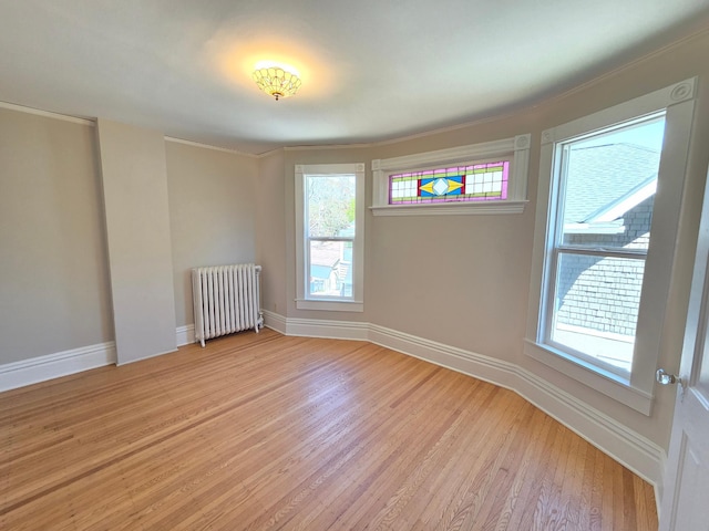 1323 Lincoln Ave, Saint Paul, MN 55105 - unfurnished room featuring radiator, light wood-style flooring, and baseboards