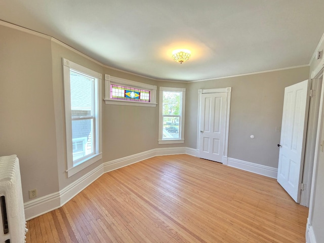 1323 Lincoln Ave, Saint Paul, MN 55105 - unfurnished bedroom featuring ornamental molding, light wood-style floors, multiple windows, baseboards, and a closet