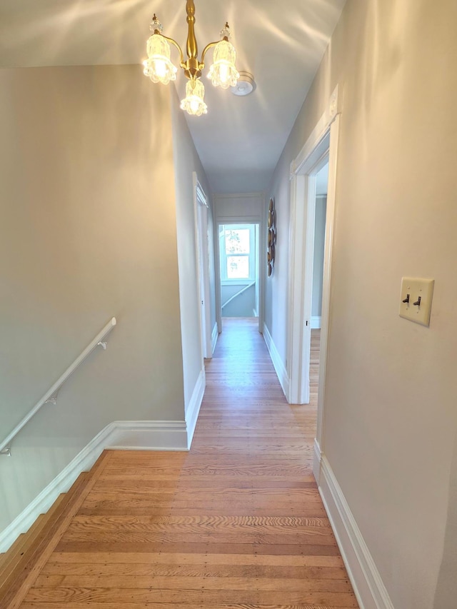 1323 Lincoln Ave, Saint Paul, MN 55105 - hallway with a chandelier, light wood finished floors, and baseboards