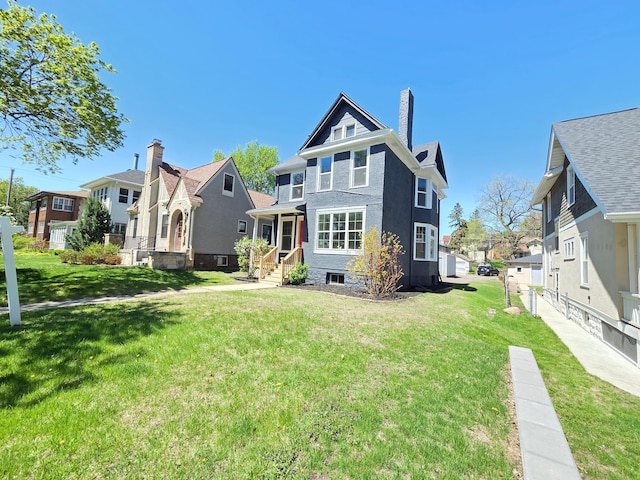 1323 Lincoln Ave, Saint Paul, MN 55105 - rear view of house with a lawn, a residential view, and a chimney