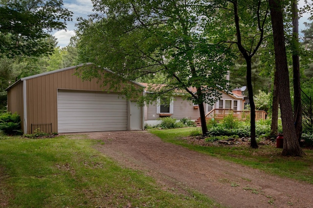 33087 Elm Ln, Motley, MN 56466 - view of front of home with dirt driveway, a deck, and an attached garage