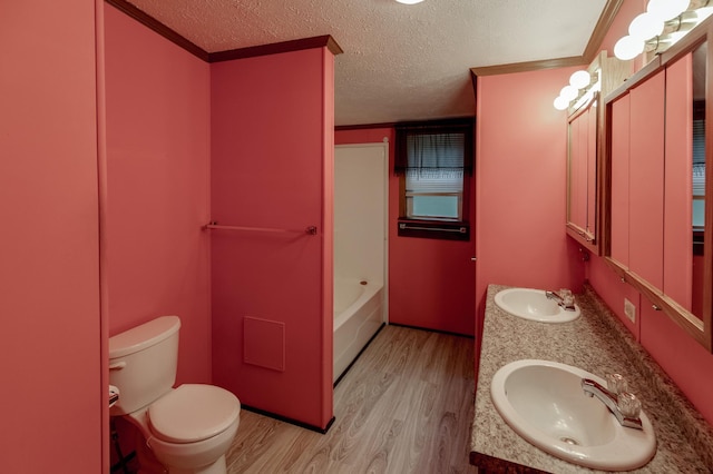 33087 Elm Ln, Motley, MN 56466 - bathroom featuring wood finished floors, double vanity, a textured ceiling, and crown molding