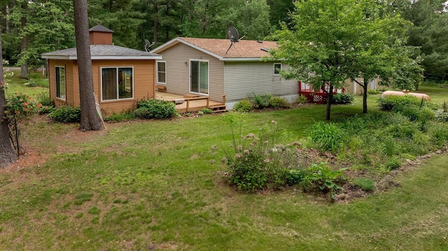 33087 Elm Ln, Motley, MN 56466 - back of house featuring a wooden deck and a yard