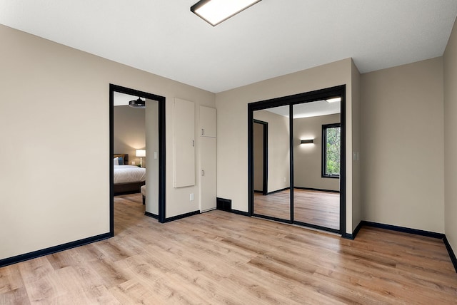 8335 Virginia Ave S, Bloomington, MN 55438 - unfurnished bedroom with light wood-type flooring and baseboards