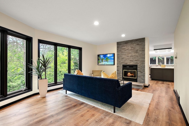 8335 Virginia Ave S, Bloomington, MN 55438 - living area featuring light wood-style flooring, healthy amount of natural light, a fireplace, and recessed lighting