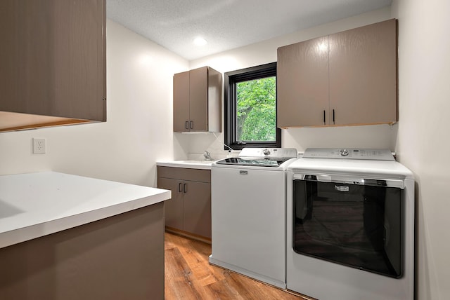 8335 Virginia Ave S, Bloomington, MN 55438 - washroom with cabinet space, washer and dryer, light wood-type flooring, a textured ceiling, and recessed lighting
