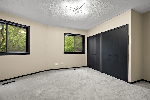 8335 Virginia Ave S, Bloomington, MN 55438 - unfurnished bedroom with a textured ceiling, carpet floors, and a closet