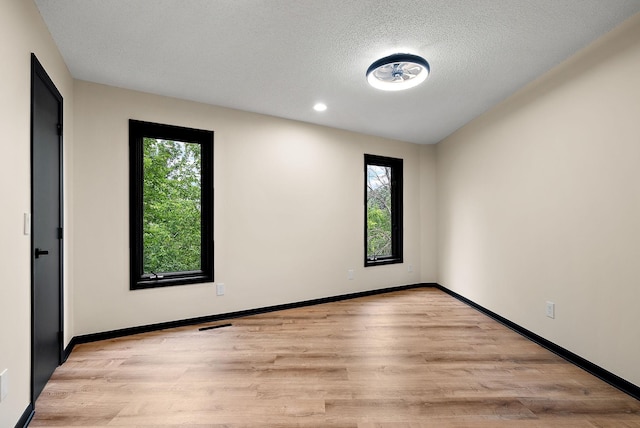 8335 Virginia Ave S, Bloomington, MN 55438 - spare room with plenty of natural light, light wood finished floors, a textured ceiling, and recessed lighting