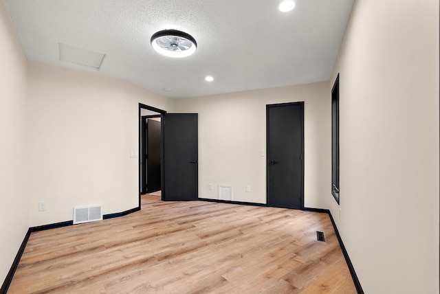 8335 Virginia Ave S, Bloomington, MN 55438 - unfurnished bedroom with attic access, wood finished floors, recessed lighting, and a textured ceiling