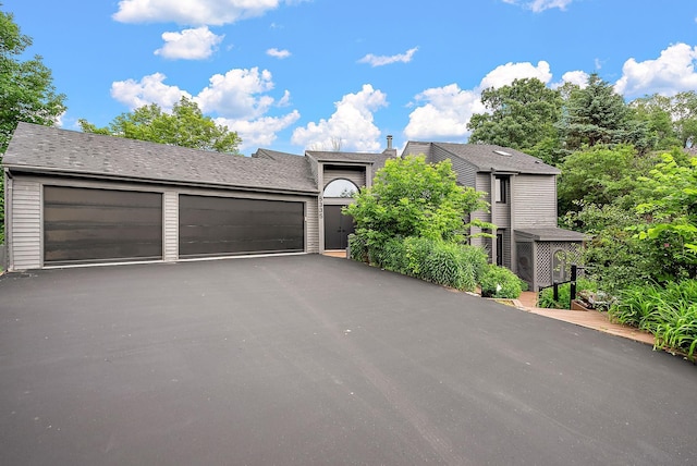 8335 Virginia Ave S, Bloomington, MN 55438 - view of front of home with asphalt driveway and an attached garage