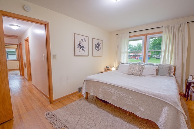 905 24th Ave N, Saint Cloud, MN 56303 - bedroom with light wood finished floors and multiple windows