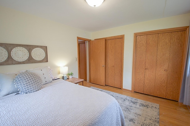905 24th Ave N, Saint Cloud, MN 56303 - bedroom featuring two closets and light wood-style floors