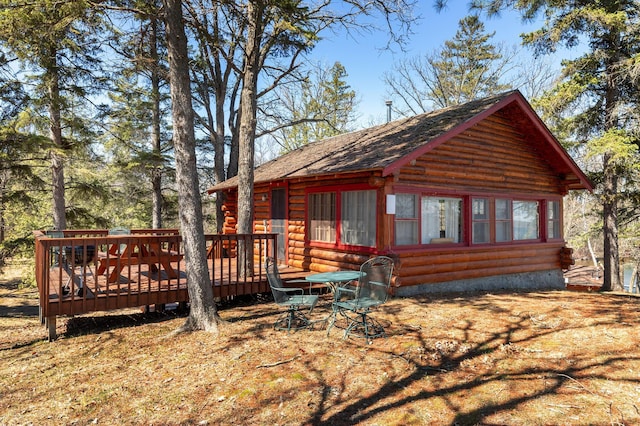 7520 Trophy Trl NW, Walker, MN 56484 - view of front of home featuring a wooden deck, log exterior, and a shingled roof
