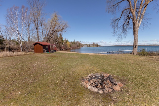 7520 Trophy Trl NW, Walker, MN 56484 - view of green lawn with a water view, a storage shed, and a fire pit