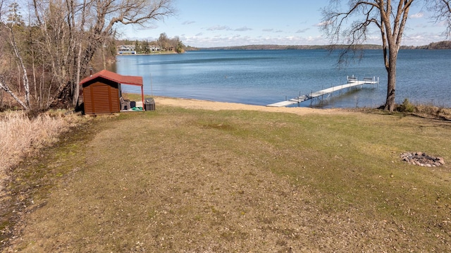 7520 Trophy Trl NW, Walker, MN 56484 - view of green lawn featuring a water view, a boat dock, and a storage unit