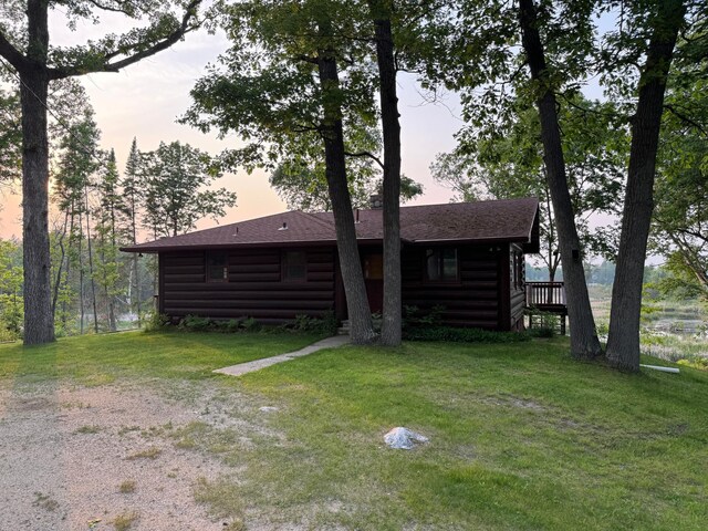 7520 Trophy Trl NW, Walker, MN 56484 - view of front of property featuring log veneer siding, a yard, and a shingled roof