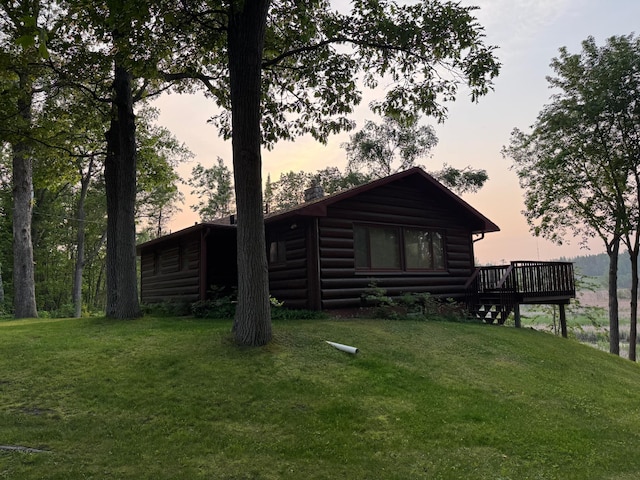 7520 Trophy Trl NW, Walker, MN 56484 - rear view of house featuring faux log siding, a deck, and a lawn