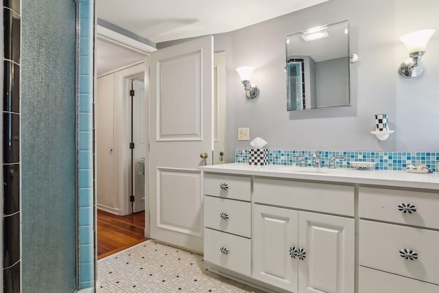11155 Mill Run, Minnetonka, MN 55305 - bathroom featuring vanity, tasteful backsplash, and a shower with shower door