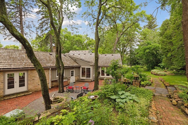 11155 Mill Run, Minnetonka, MN 55305 - rear view of house with a patio, brick siding, french doors, and board and batten siding