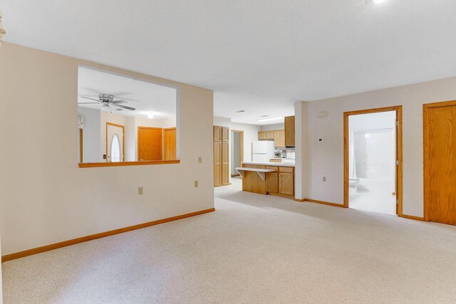 5645 Wisconsin Ave N, New Hope, MN 55428 - unfurnished living room featuring light colored carpet and a ceiling fan