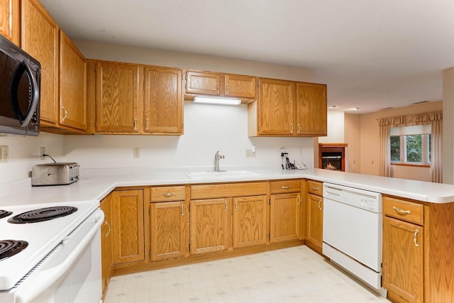 5645 Wisconsin Ave N, New Hope, MN 55428 - kitchen with white appliances, a peninsula, light floors, light countertops, and brown cabinets
