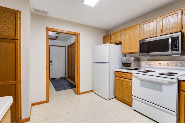 5645 Wisconsin Ave N, New Hope, MN 55428 - kitchen with white appliances, light flooring, and light countertops