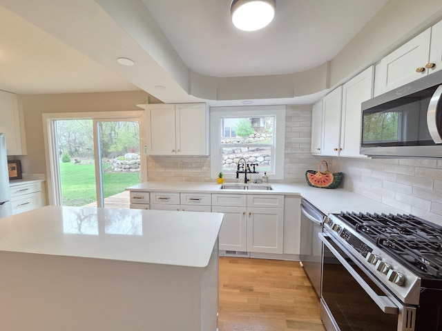 13801 Lake Street Ext, Minnetonka, MN 55345 - kitchen with stainless steel appliances, a sink, healthy amount of natural light, and light countertops