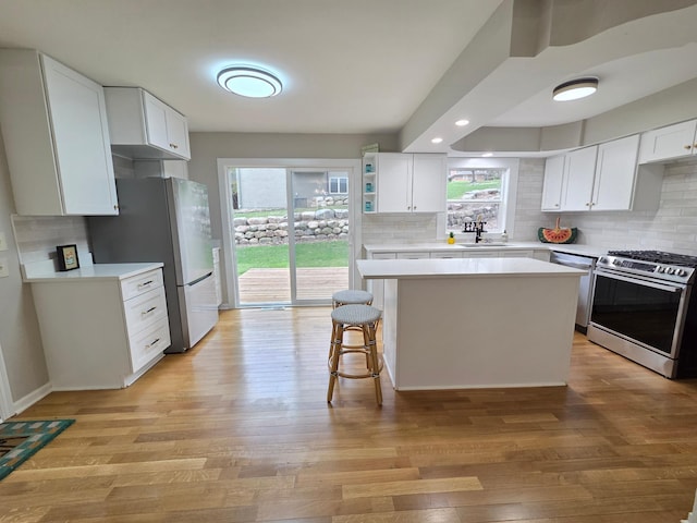 13801 Lake Street Ext, Minnetonka, MN 55345 - kitchen featuring appliances with stainless steel finishes, tasteful backsplash, light countertops, light wood-style flooring, and recessed lighting