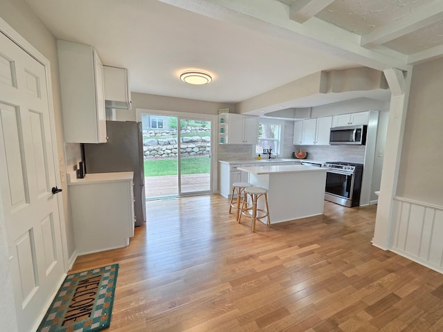 13801 Lake Street Ext, Minnetonka, MN 55345 - kitchen with appliances with stainless steel finishes, light wood-style flooring, decorative backsplash, beamed ceiling, and light countertops
