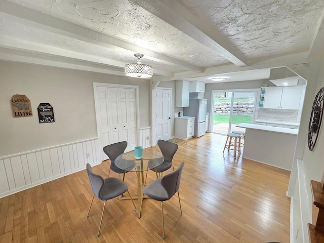 13801 Lake Street Ext, Minnetonka, MN 55345 - dining area featuring light wood-type flooring, beamed ceiling, and wainscoting