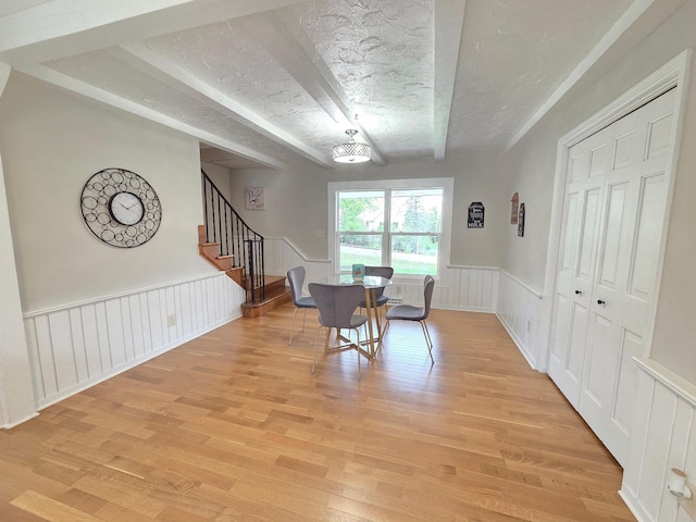 13801 Lake Street Ext, Minnetonka, MN 55345 - dining space featuring light wood-style flooring, stairs, and a wainscoted wall