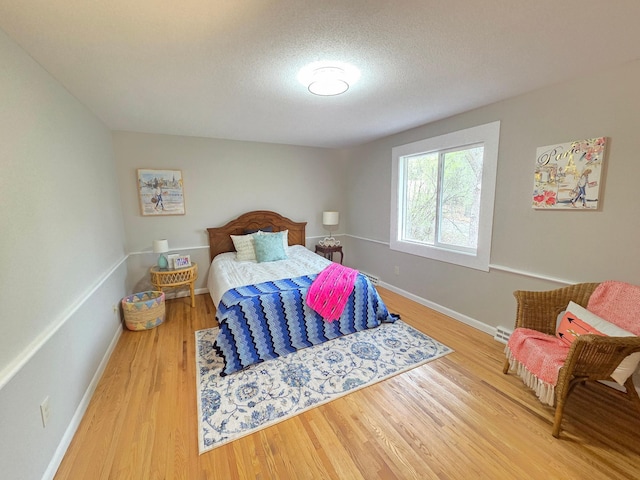 13801 Lake Street Ext, Minnetonka, MN 55345 - bedroom featuring wood finished floors, baseboards, and a textured ceiling