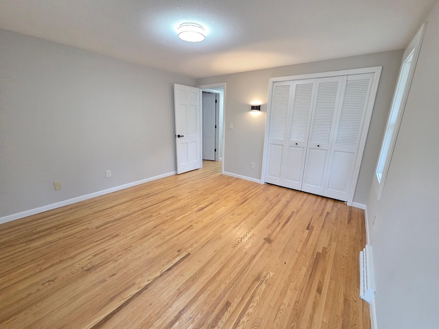 13801 Lake Street Ext, Minnetonka, MN 55345 - unfurnished bedroom featuring light wood finished floors, baseboards, and a closet