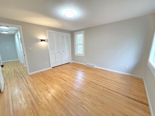 13801 Lake Street Ext, Minnetonka, MN 55345 - unfurnished bedroom featuring light wood-style flooring, baseboards, and a closet