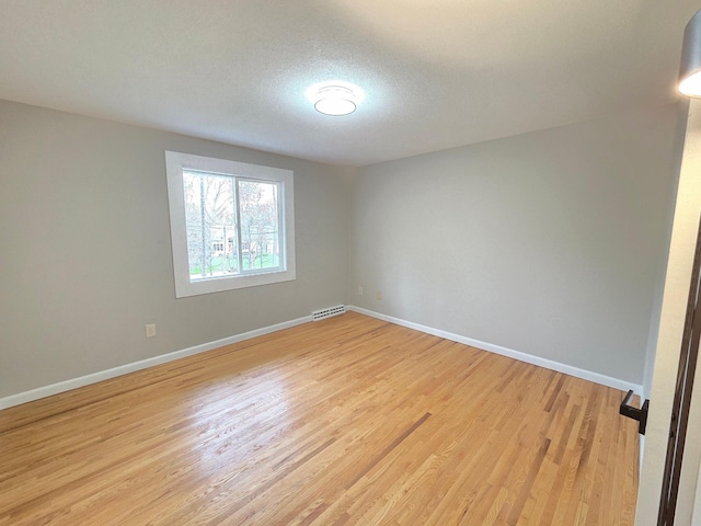 13801 Lake Street Ext, Minnetonka, MN 55345 - spare room featuring baseboards, light wood finished floors, and a textured ceiling