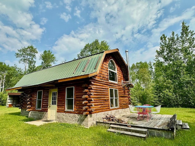 3274 County Road 1 SW, Boone Twp, MN 56623 - back of house with log siding, a deck, a gambrel roof, a yard, and metal roof