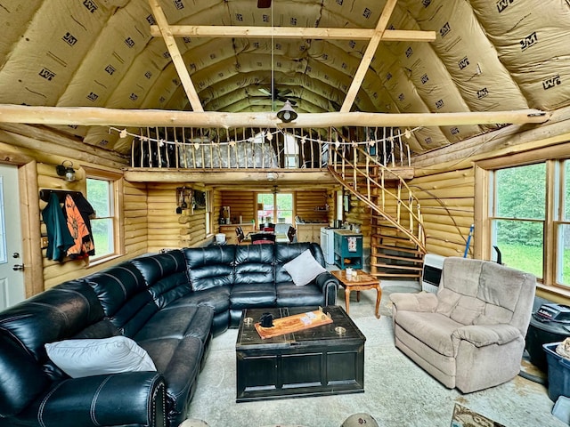 3274 County Road 1 SW, Boone Twp, MN 56623 - living room featuring rustic walls, high vaulted ceiling, stairs, and carpet