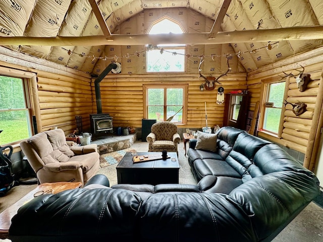 3274 County Road 1 SW, Boone Twp, MN 56623 - living area with high vaulted ceiling, rustic walls, and a wood stove