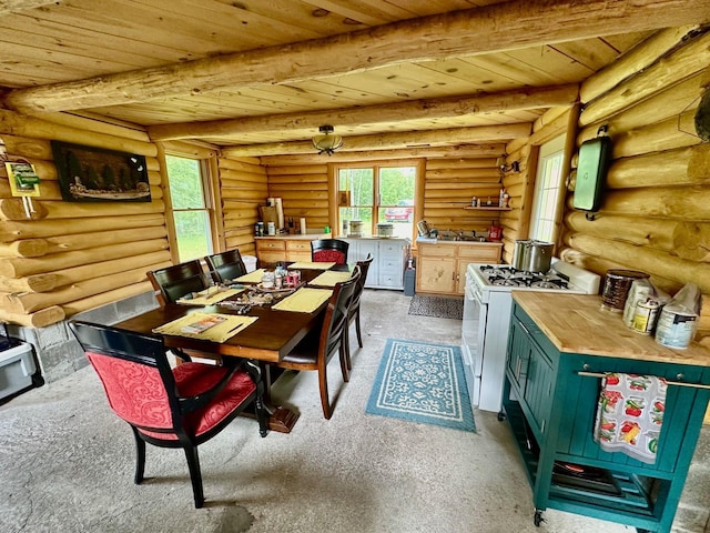 3274 County Road 1 SW, Boone Twp, MN 56623 - dining area featuring wood ceiling with exposed beams, light colored carpet, healthy amount of natural light, and rustic walls