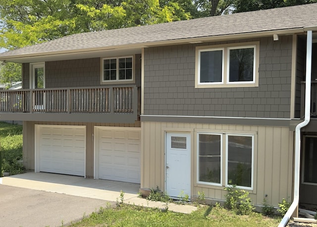7611 Iroquois St, Chanhassen, MN 55317 - view of front facade with roof with shingles, a garage, driveway, and a balcony