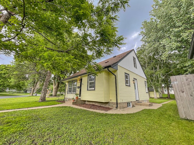 4241 Tyler St NE, Columbia Heights, MN 55421 - view of front of house with a front yard and roof with shingles