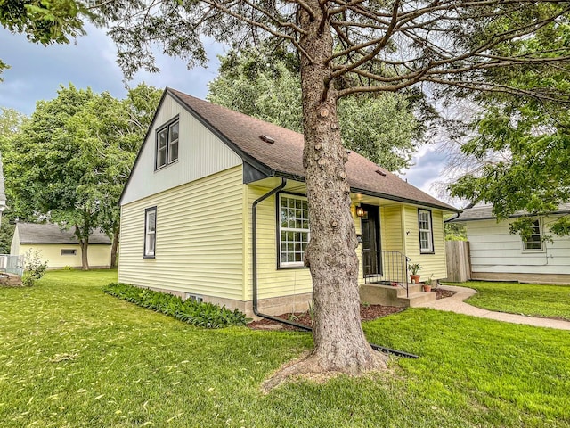 4241 Tyler St NE, Columbia Heights, MN 55421 - view of front of property with roof with shingles and a front lawn
