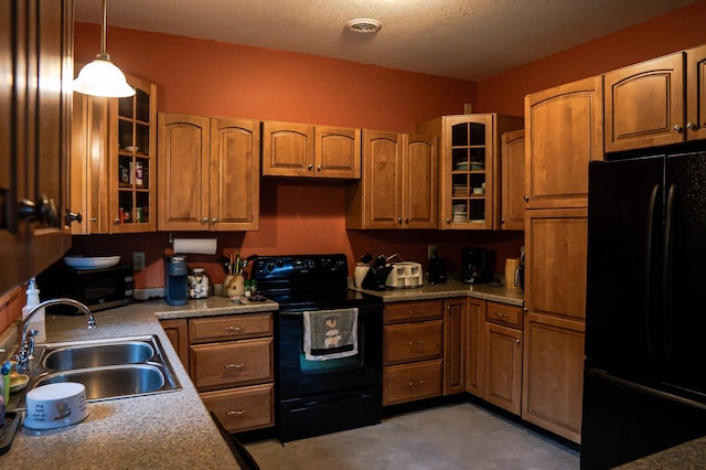 10804 Splithand Rd, Wildwood Twp, MN 55744 - kitchen featuring black appliances, a sink, brown cabinetry, decorative light fixtures, and glass insert cabinets