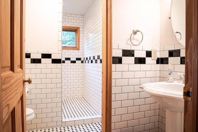 10804 Splithand Rd, Wildwood Twp, MN 55744 - full bath with tile walls, a shower stall, toilet, and a wainscoted wall