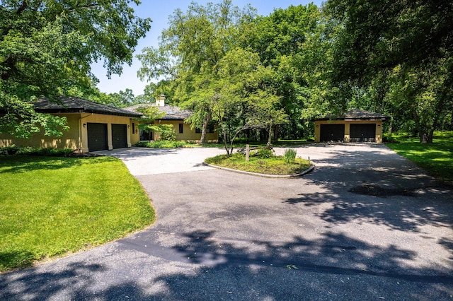 28647 State Highway 78, Otter Tail Twp, MN 56515 - view of front of house featuring driveway, a front lawn, an attached garage, and stucco siding