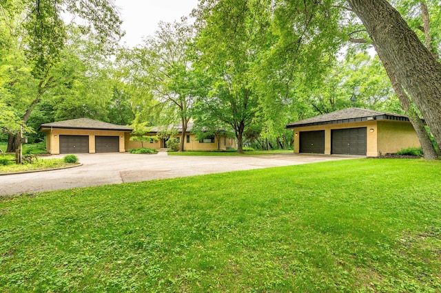 28647 State Highway 78, Otter Tail Twp, MN 56515 - view of front of home with a detached garage, a front lawn, and stucco siding