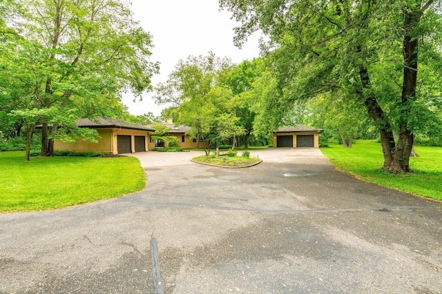 28647 State Highway 78, Otter Tail Twp, MN 56515 - view of front of house featuring a front yard, driveway, stucco siding, and a garage
